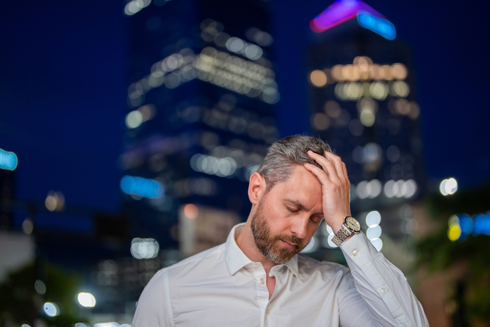 Man Holding His Head Stressed In The City.jpg
