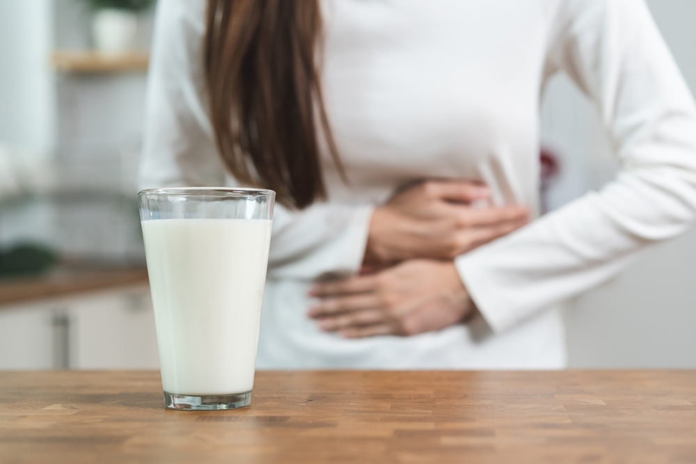 Woman Holding Stomach Lactose Intolerance.jpg